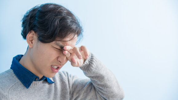 Man,Student,Feel,Eye,Discomfort,With,Isolated,Blue,Background,,Asian