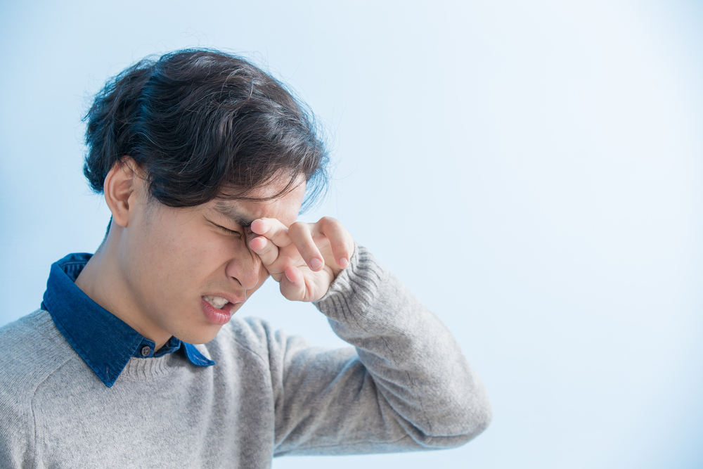 Man,Student,Feel,Eye,Discomfort,With,Isolated,Blue,Background,,Asian