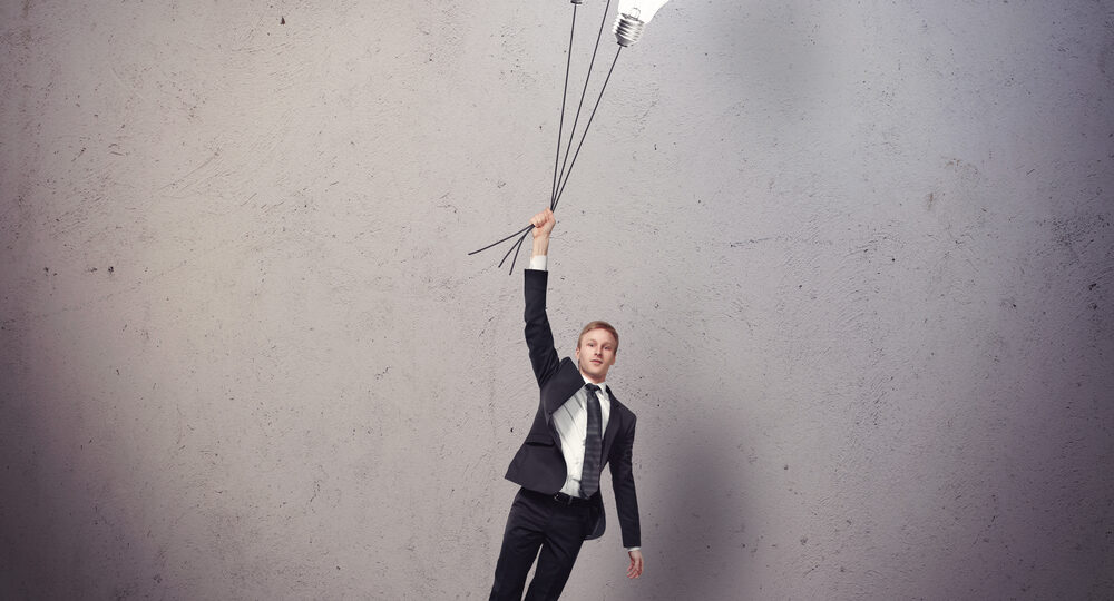 Businessman,Flying,With,Light,Bulbs