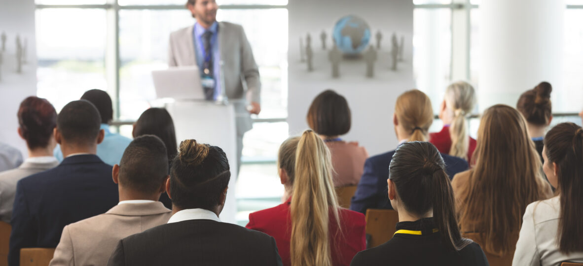 Rear,View,Of,Group,Of,Diverse,Business,People,Listening,To