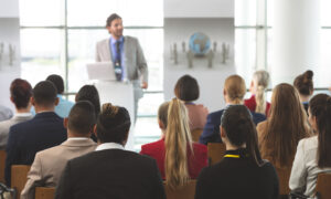 Rear,View,Of,Group,Of,Diverse,Business,People,Listening,To