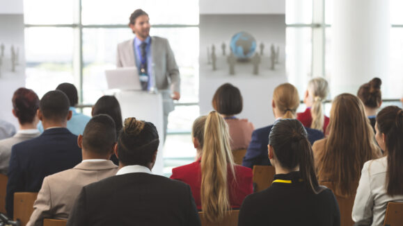 Rear,View,Of,Group,Of,Diverse,Business,People,Listening,To